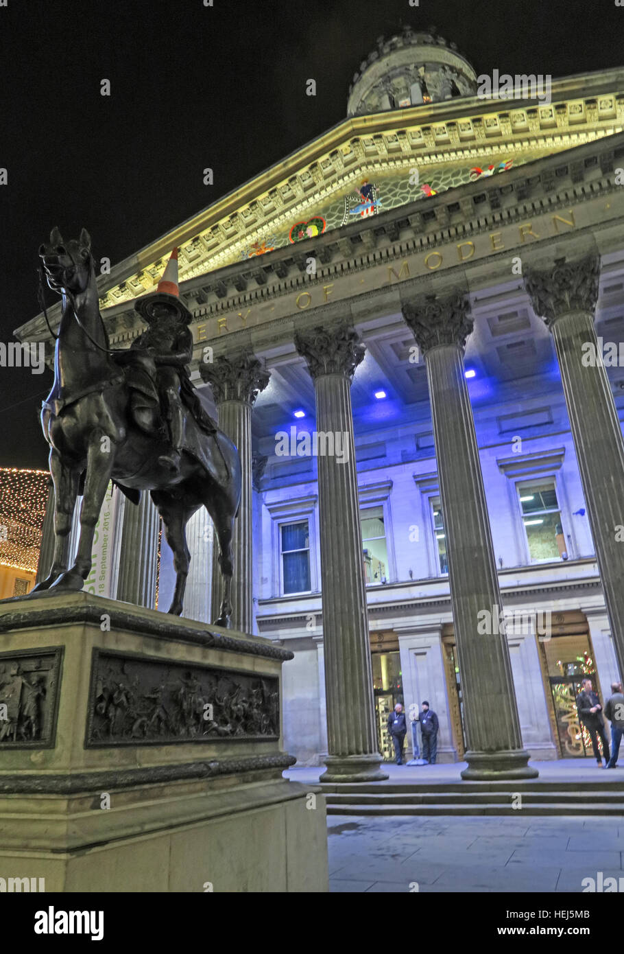 Glasgow-Gebäude von der Merchant City, Schottland in der Nacht - GOMA und Verkehr Kegel auf Kopf des Herzogs von Wellington Stockfoto