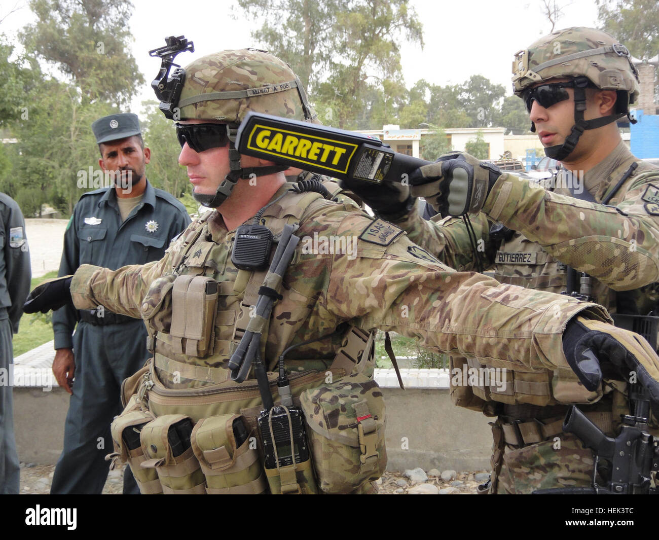 US Army Staff Sgt Javier Gutierrez (rechts), gebürtig aus San Antonio, und US Armee Sgt. Caleb Meeker, von Apache Junction, Arizona, beide Mitglieder des Headquarters und Headquarters Company, 3. Brigade spezielle Truppen Bataillon, 3rd Brigade Combat Team, 25. Infanterie-Division, TF Bronco, verwenden Sie eine neue Metalldetektoren Zauberstab und zeigen Sie afghanischen Zollfahnder, wie man eine Personalsuche in Jalalabad Zollhaus 11 Juni durchzuführen. Militärpolizei teilen Taktiken, liefern Ausrüstung, Jalalabad Zoll Depot 415296 Stockfoto