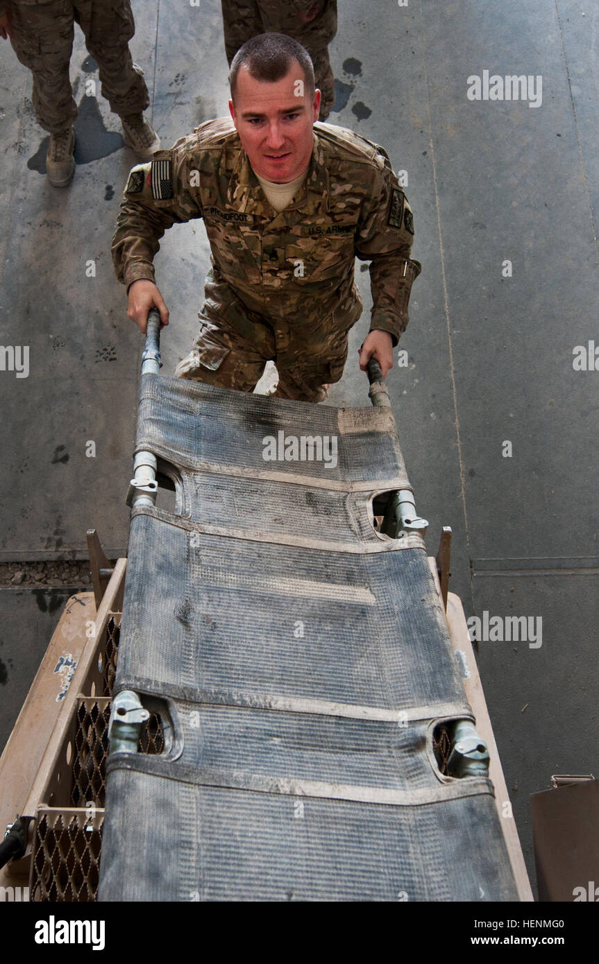 Staff Sgt Jamie Proudfoot, 10. Sustainment Brigaden senior Kaplan Assistent, gebürtig Linesville, PA., hilft der richtigen Weg, um einen Unfall, sicherte sich einen Wurf laden zu demonstrieren. Das CET Training zielte ein Weg, um sie mit den Funktionen von resistenten Hinterhalt geschützt Minenfahrzeuge sowie ihre Rollen auf einer Konvoi-Mission vertraut zu machen. (Foto von Sgt. Michael K. Selvage, 10. Sustainment Brigade Öffentlichkeitsarbeit NCO) (Freigegeben) Laden einen Wurf 140710-A-CA521-027 Stockfoto