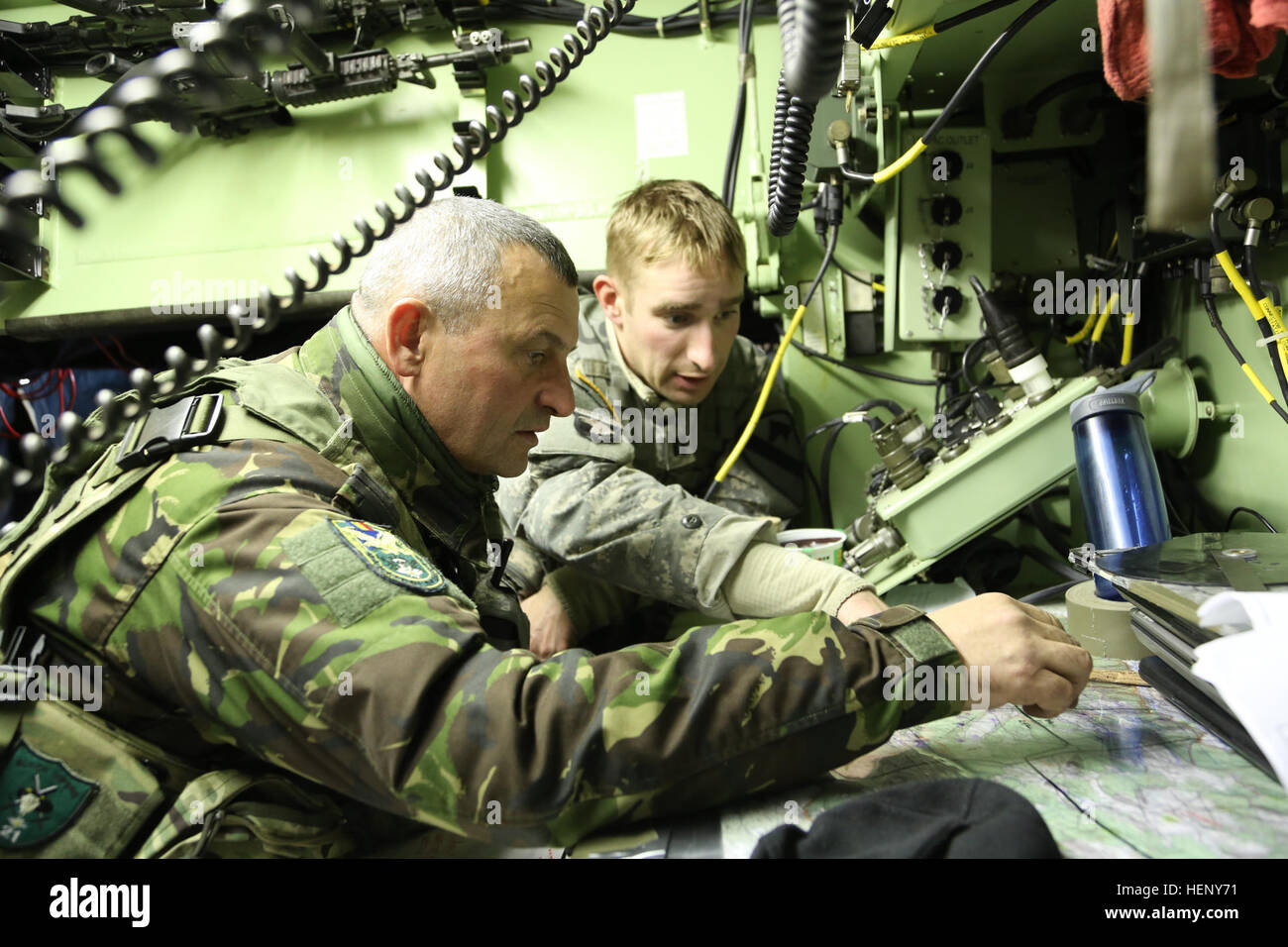 Rumänischen Oberst Ovidiu Conduruta, Kommandeur der 21. Mountain Troop Battalion, 2. Gebirgsbrigade Truppen, 1. US-Infanteriedivision Koordinaten Mission Pläne mit US Army Captain Geoff Hertenstein des 2. Bataillons, 12. Kavallerie-Regiment während der Übung kombiniert zu beheben III bei der Joint Multinational Readiness Center in Hohenfels, Deutschland, 6. November 2014.  Kombinierte Lösung III ist eine multinationale Übung, die enthält mehr als 4.000 Teilnehmer aus NATO und Partner, und soll eine komplexe Trainingsszenario bieten, die konzentriert sich auf multinationale unified Land Operationen und stärkt Stockfoto