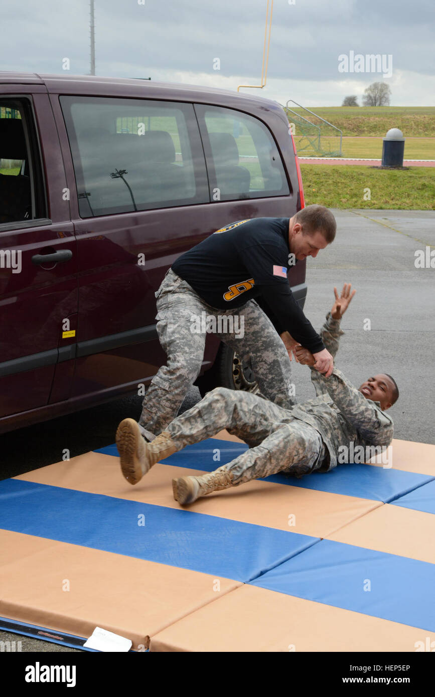 U.S. Army Sgt.1st Klasse Bryan Norris, mit Hauptsitz schnelle Reaktion Korps-Frankreich, erklärt die Gewinnung einer nicht konformen Person aus einem Fahrzeug während der taktischen Combatives Kurse Level 2, Parkplatz des Hangar 4 Erholung Gemeindezentrum, in Chièvres Air Base, Belgien, 24. Februar 2015. (US Armee-Foto von visuellen Informationen Spezialist Pascal Demeuldre veröffentlicht) Taktische Combatives Kurse Stufe II in Chièvres Air Base 150224-A-RX599-033 Stockfoto