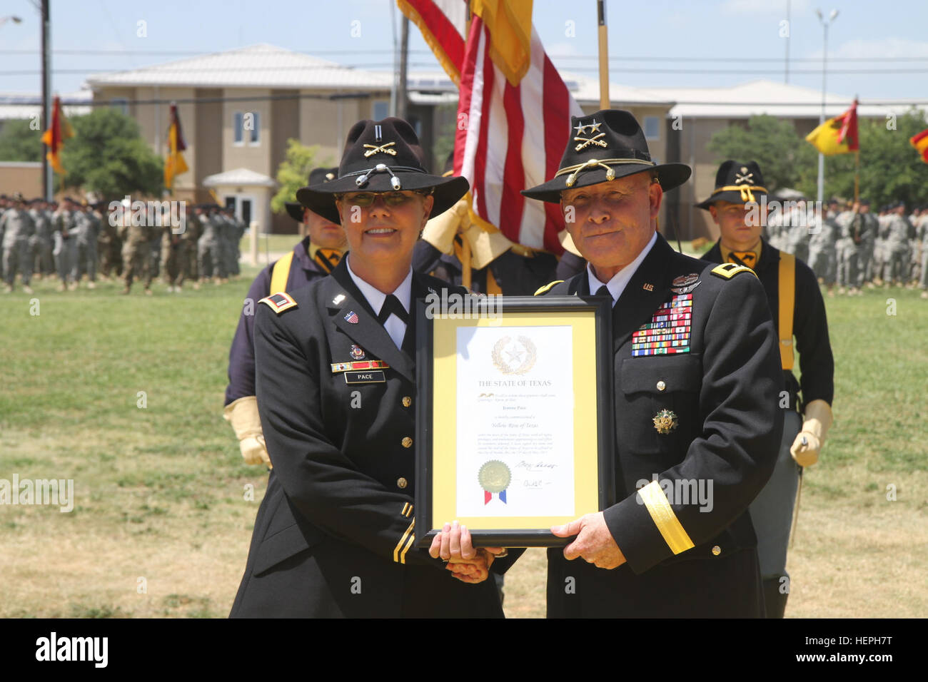 Chief Warrant Officer 5 Jeanne Pace (links), ehemaliger Kapellmeister für die 1. Kavallerie-Division-Band präsentiert mit einer Gedenktafel von Generalmajor Michael Bills, Kommandierender general, 1. Kavallerie-Division, Inbetriebnahme ihr als eine gelbe Rose von Texas von Texas Gouverneur Greg Abbott, während ihre Abschiedsfeier Juli 10 auf Cooper Feld in Fort Hood, Texas. Tempo im Ruhestand, nachdem er mehr als 43 Jahre in der Armee. (Foto: U.S. Army Staff Sgt Christopher Calvert, 1. Kavallerie-Division-PAO/freigegeben) Soldat in den Ruhestand nach 43 jährigen Karriere 150710-A-WD324-070 Stockfoto