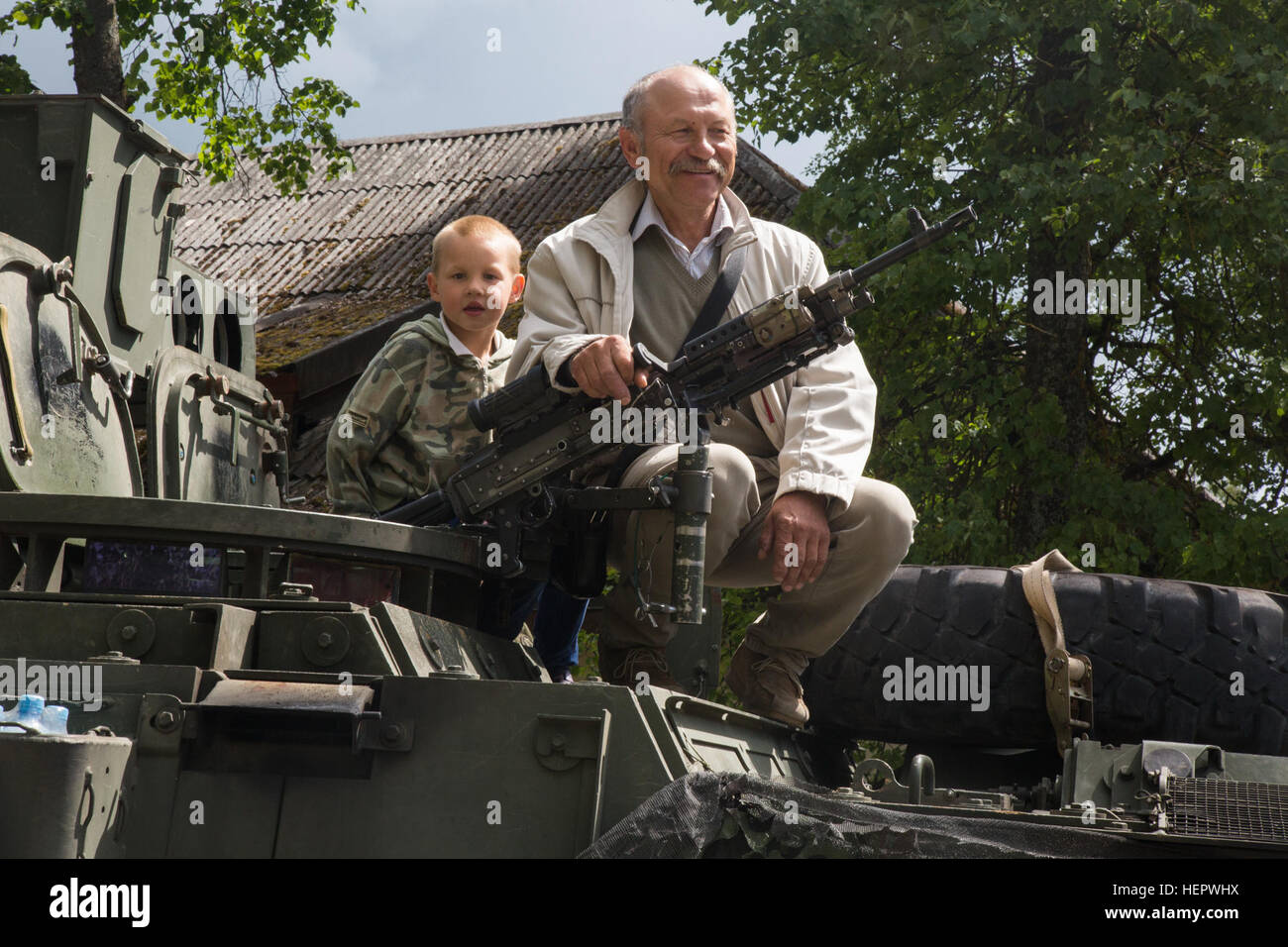 Lokale Bürger darstellen oben auf einem Stryker Armored Fighting Vehicle während eine statische Anzeige Setup von 4. Geschwader, 2. Kavallerie-Regiment in einem Park in Kupiskis, Litauen 12. Juni 2016, während Dragoon Ride II, 2.200 Kilometer Konvoi nach Estland für Übung Saber Strike 16. Übung Saber Strike 16 ist ein unter der Leitung von US-Army in Europa kooperative Übung zur Verbesserung der gemeinsamen Interoperabilität zur Unterstützung multinationaler Einsätze. (US Armee-Foto von Staff Sgt. Ricardo HernandezArocho/freigegeben) Säbel-Strike 2016 Konvoi 160612-A-DM872-175 Stockfoto