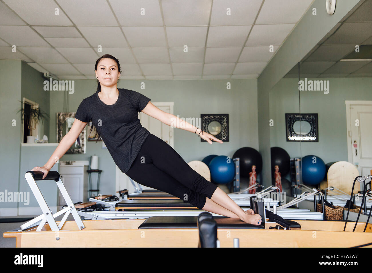 Frau im Fitness-Studio mit Pilates-reformer Stockfoto