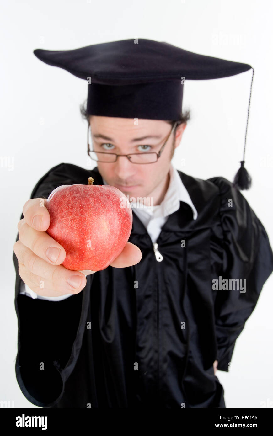 Absolvent mit einem Apfel, Symbol für "Food For Thought" Stockfoto