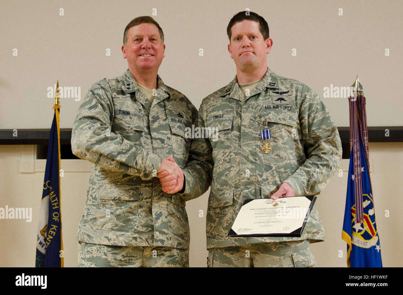 Kentuckys Generaladjutant, Generalmajor Edward W. Tonini, präsentiert Captain Nathan Tingle, 12. Januar 2014, an der Kentucky Air National Guard Base in Louisville, Kentucky Prickeln verdient den Preis für außerordentliche Leistungen während der Durchführung von Rettungseinsätzen in Afghanistan im Jahr 2011 ein Kampf Rettung Offizier in der 123. spezielle Taktik-Staffel mit dem Distinguished Flying Cross während einer Preisverleihung statt. (Foto: U.S. Air National Guard Flieger 1. Klasse Joshua Horton) Kentucky-Flieger für Heldentum und Dienst in Afghanistan 140112-Z-DI861-099 geehrt Stockfoto