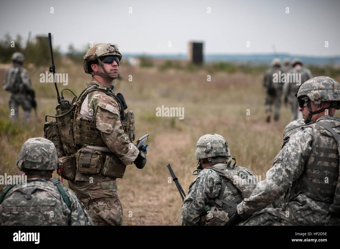 Senior Airman Tyler Trocano, Center, eine gemeinsame Terminal Air Controller von 148. Air Support Operations Squadron, Fort Indiantown Gap, PA sucht ein AH-64 Apache Hubschrauber von Charlie Kompanie 1-104. Angriff Reconnaissance Battalion, Fort Indiantown Gap, PA., für Luftnahunterstützung zum Schutz der Mitglieder der 2. Zug, Charlie Truppe, Team 2: 2, 1-126 Kavallerie-Regiment, Michigan National Guard, Koppy, Michigan während der Operation Northern Strike 2014 in der Nähe von Äsche , Michigan am 11. August 2014. Operation Northern Strike 2014 ist eine gemeinsame multinationale kombinierte Waffen training Übung in Michig durchgeführt Stockfoto