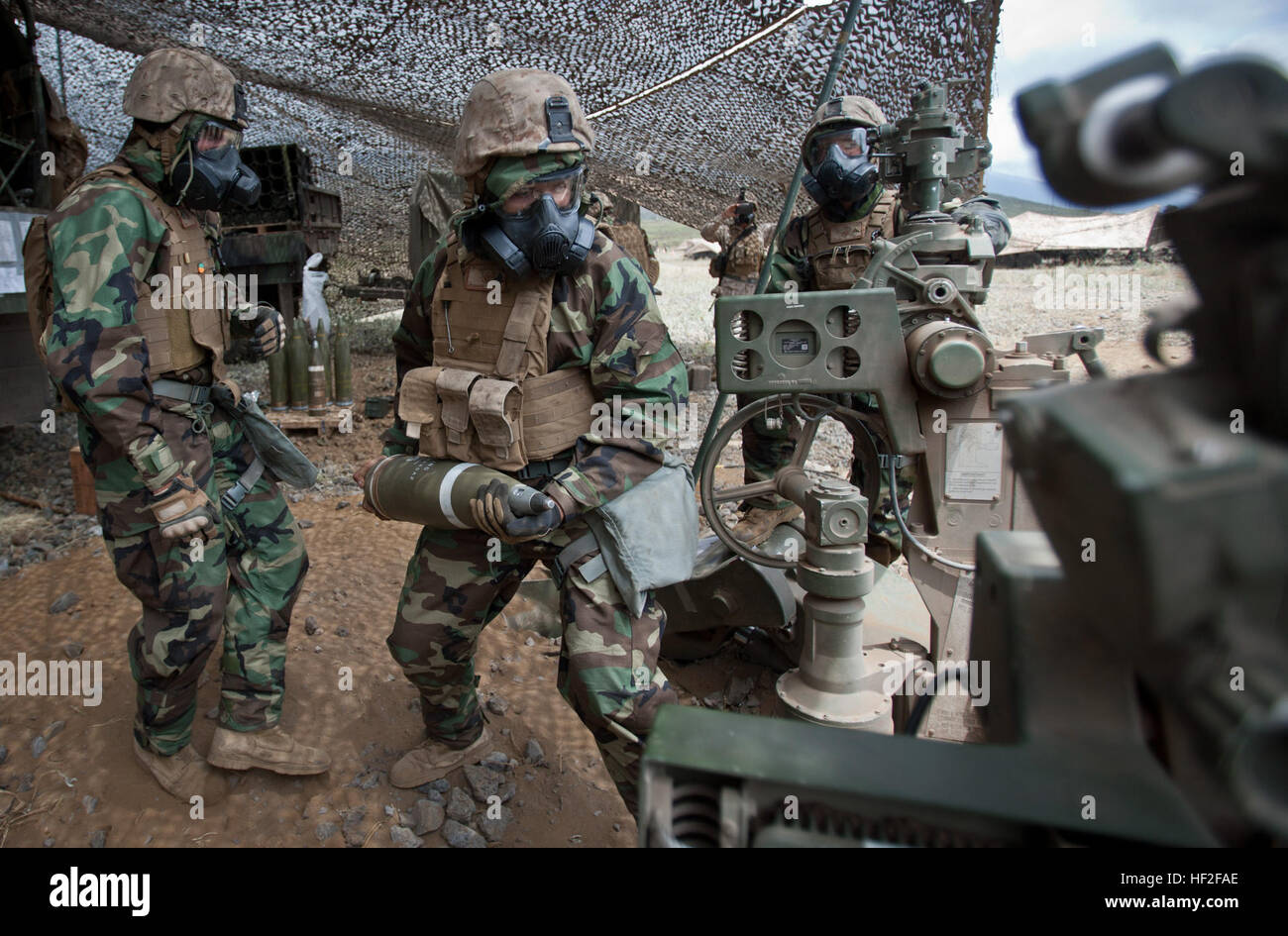 US Marine Cpl.Tristan Messenger, eine Artillerie-Cannoneer zugewiesen, 1. Bataillon, 12. Marine Regiment, Alpha Batterie lädt eine leuchtende Runde auf die Haubitze M777 während einer Feuer-Mission nach eine chemische, biologische, radiologische, nukleare (CBRN) Angriff Simulation an Bord Pohakuloa Training Bereich (PTA), Hawaii, Sept. 7, 2014. Mitglieder des 1. Bataillons, 12. Marines (1/12), sind Steigerung ihrer Fähigkeiten des direkten Feuerunterstützung zur Unterstützung Betrieb spartanisch Zorn. (Foto: U.S. Marine Corps Lance Cpl. Victor A. Mancilla/freigegeben) Spartanisch Zorn 2014, 1-12 140907-M-AU949-002 Stockfoto