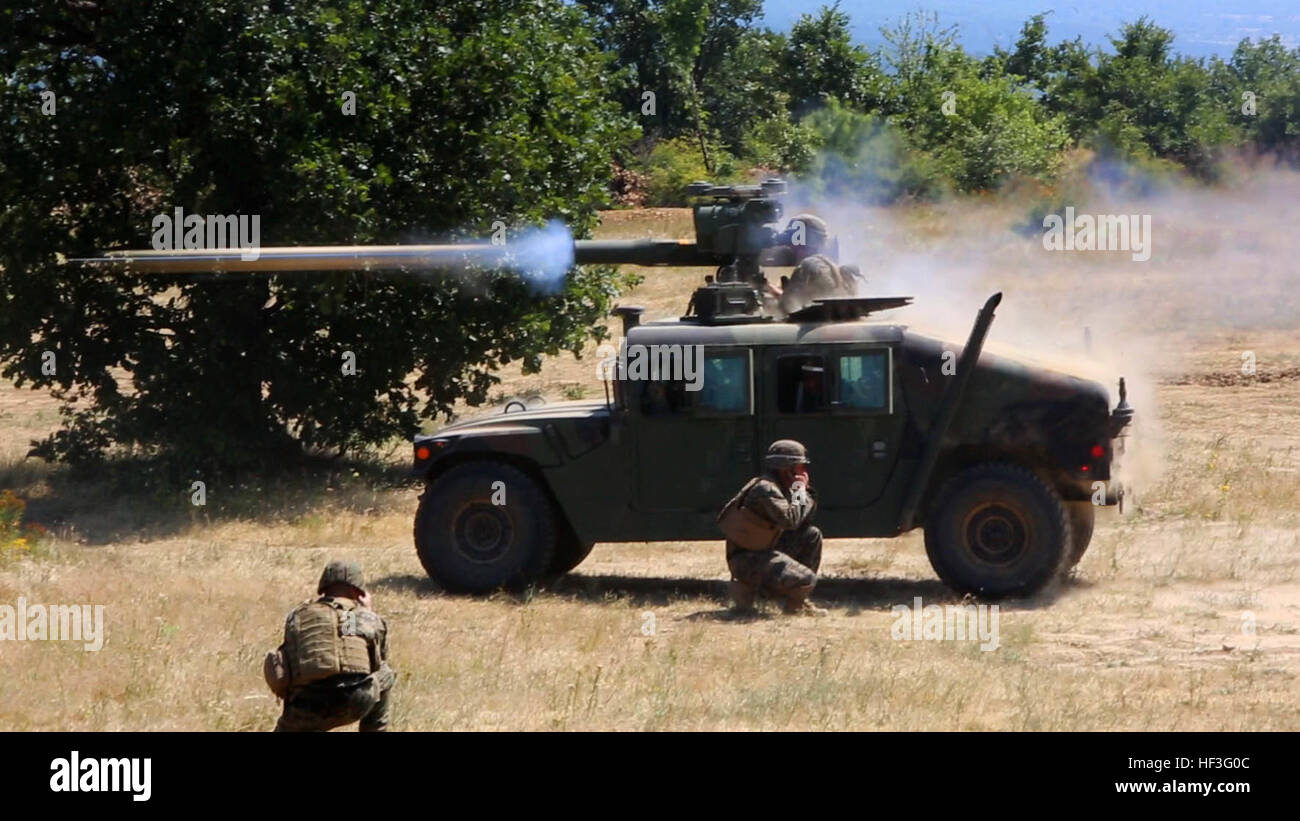 US Marine Lance CPL Gordon Kwei, Anti-Tank Flugkörper Mann mit Waffen Firma, Schwarzmeer Drehkraft, feuert die Rohr-ins Leben gerufen, optisch getrackten, Draht-geführte Anti-Tank Flugkörper (TOW), während Staff Sgt Wayne Edmiston, Bekämpfung Korrespondent mit Schwarzmeer Drehkraft, es am Anti-Panzer-Auswahlmannschaft Durchhaltefähigkeit Training für Übung Platin Löwen 15-3, Juli 8 Truppenübungsplatz Novo Selo, Bulgarien zeichnet. Die Marines gestartet 10 TOW-Raketen abgefeuert von M41 Säbel an den Türmen der Humvees befestigt.  Marines mit Schwarzmeer Drehkraft und Service-Mitglieder aus Bulgarien, Rumänien, Stockfoto