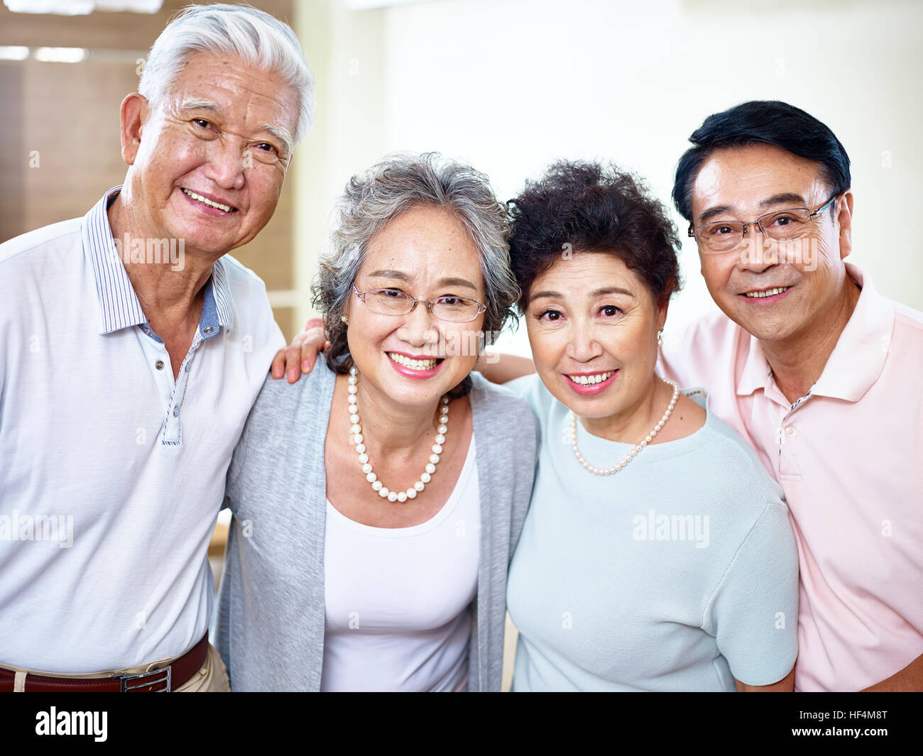 zwei ältere asiatische Ehepaare Blick auf die Kamera zu Lächeln. Stockfoto