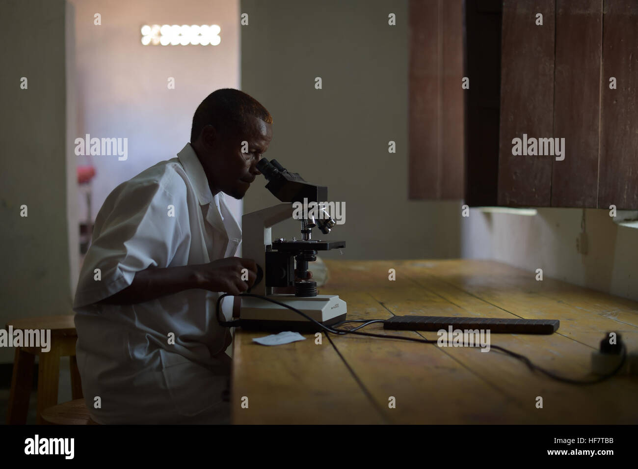 Eine Laborantin prüft eine Blutprobe für Malaria in Barawe, Somalia, am 23. August 2016. Barawe, früher eine Stronhold der terroristischen Gruppe al-Shabab, wurde aus der Gruppe vor fast zwei Jahren von der Mission der Afrikanischen Union in Somalia erobert und ist seitdem in staatlicher Hand.  / Tobin Jones Stockfoto