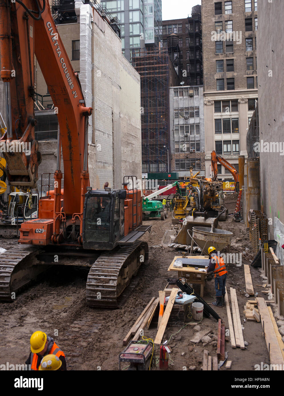 Schweres Gerät wird verwendet, um Gründungsarbeiten für ein Hochhaus Büro- und Wohngebäude in New York City zu vervollständigen. Stockfoto