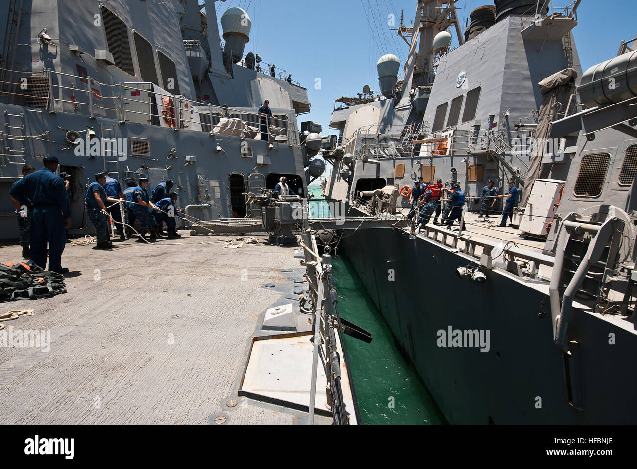 120625-N-WO496-003 MINA SALMAN PIER, Bahrain (25. Juni 2012) Segler, die geführte Flugkörper-Zerstörer USS Porter (DDG-78), rechten und USS Milius (DDG-69) zugewiesen entfernen Gangplank zwischen ihren zwei Schiffen als Porter bereitet, Bahrain abzuweichen. Beide Schiffe werden in den USA bereitgestellt 5. Flotte Aufgabengebiet Durchführung von maritimen Sicherheits-Operationen und Sicherheitsbemühungen Zusammenarbeit Theater. (Foto: U.S. Navy Mass Communication Specialist 2. Klasse Alex Forster/freigegeben) - offizielle US Navy Bilder - Segler entfernen Gangplank zwischen ihren zwei Schiffen als Porter bereitet, Bah abzuweichen Stockfoto