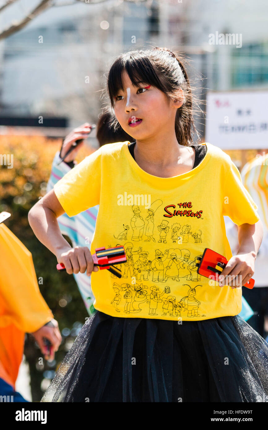 Japan, Kumamoto. Hinokuni Yosakoi Festival. Kind Tänzer, Mädchen, 11-12 Jahre, im Simpsons top, naruko, hölzerne Klöppel, Tanzen im Freien. Stockfoto