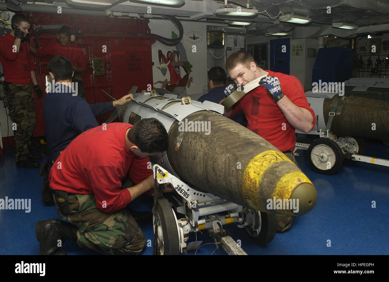 030319-N-4142G-016 am Arabischen Golf (19. März 2003)--Aviation Ordinanceman 3. Klasse Jovino Hernandez und Luftfahrt Ordinanceman Flieger Matt Ethridge Joint Direct Attack Munition (JDAM) Bomben in den vorderen Chaos Decks montieren bevor sie auf Aufzüge für Flugzeuge auf dem Flugdeck an Bord der USS Constellation (CV-64) geleitet.  JDAM gibt Anleitung-Kits, die bestehenden ungelenkte Bomben präzisionsgelenkte Munition der "intelligenten" umzuwandeln. Heckteil enthält ein Inertiales Navigationssystem (INS) und ein global positioning System (GPS).  JDAM verbessert die Genauigkeit der ungelenkte Bomben in jedem weat Stockfoto