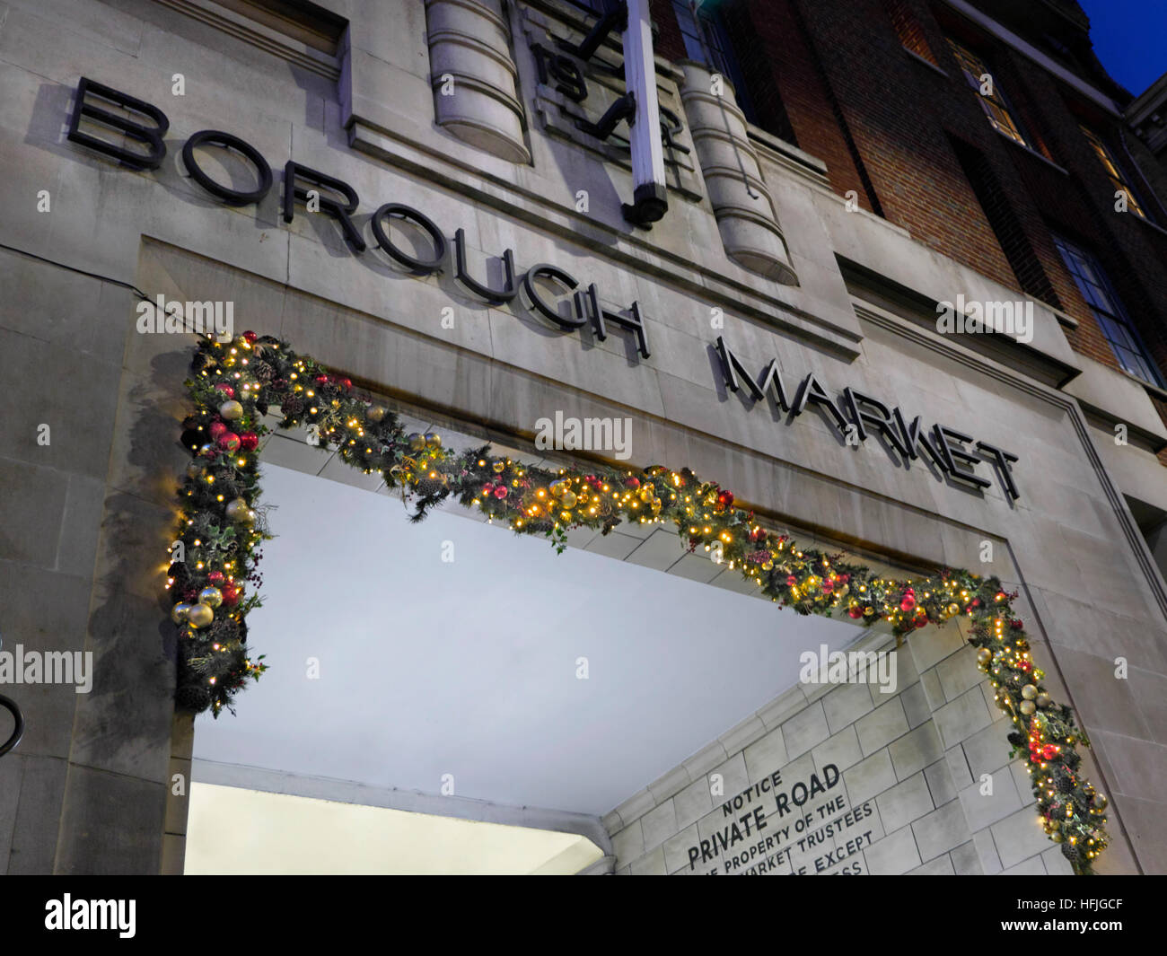 Eingang zum Borough Market mit beleuchtete Weihnachtsgirlande nachts Southwark London Stockfoto