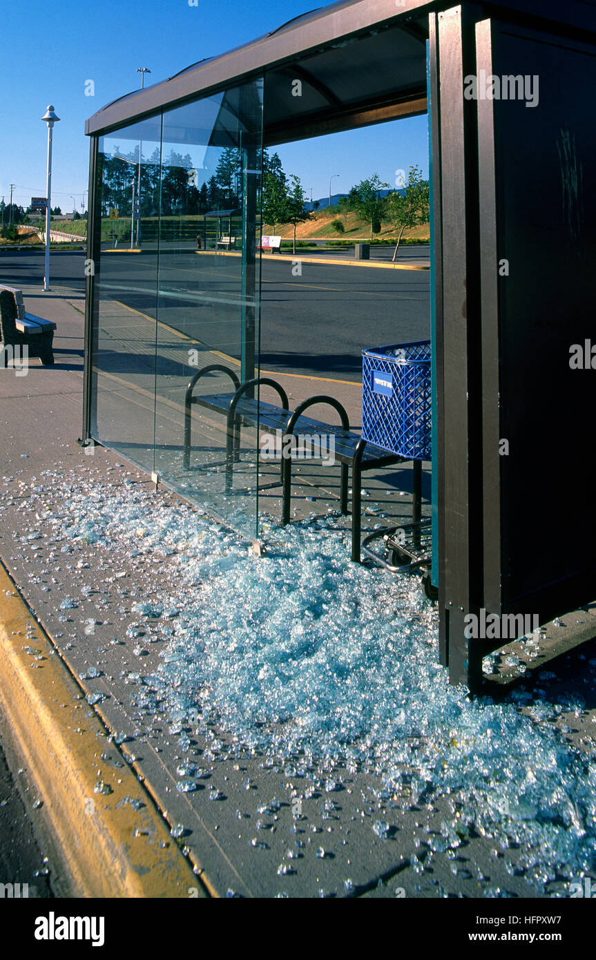 Vandalismus an Bushaltestelle, Vandalized Wartehalle - gebrochene Glasscherben auf Bürgersteig Stockfoto