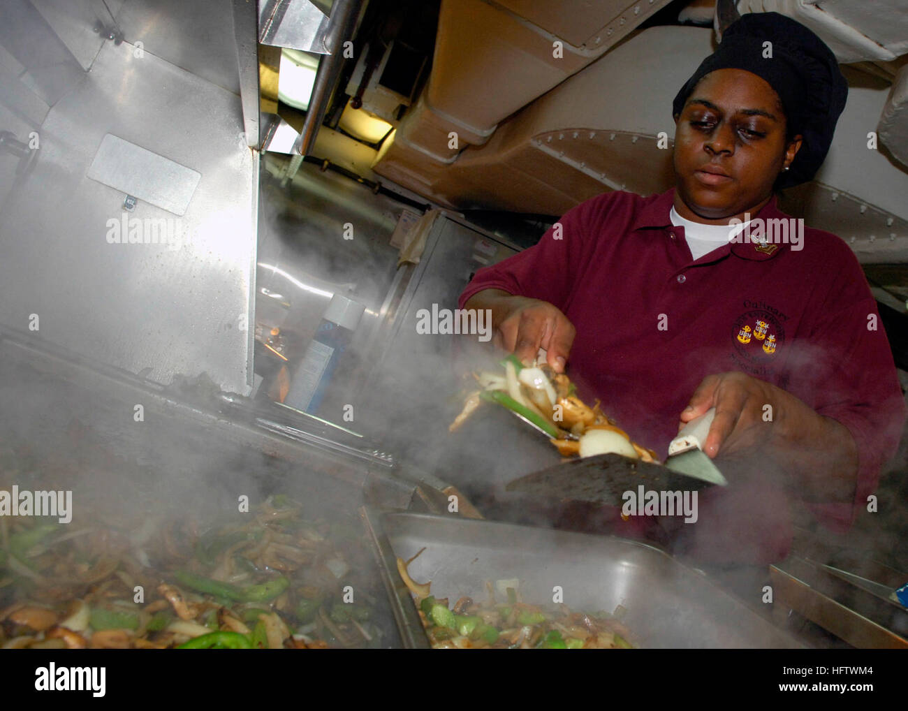 070729-N-6524M-003-Mittelmeer (29. Juli 2007) - kulinarische Spezialist 2. Klasse Lakia Davidson bereitet Gemüse unter Rühren braten für Mitglieder des Häuptlings Durcheinander an Bord der nuklear angetriebene Flugzeugträger USS Enterprise (CVN-65). Enterprise und eingeschifften Carrier Air Wing (CVW) 1 sind im Gange auf einen geplanten Einsatz zur Unterstützung der globalen Krieg gegen den Terrorismus. US Navy Foto von Masse Kommunikation Spezialist Seemann Brandon Morris (freigegeben) US Navy 070729-N-6524M-003 kulinarische Anbieter 2. Klasse Lakia Davidson bereitet Gemüse unter Rühren braten für Mitglieder des Häuptlings Durcheinander an Bord Atom-Aircra Stockfoto