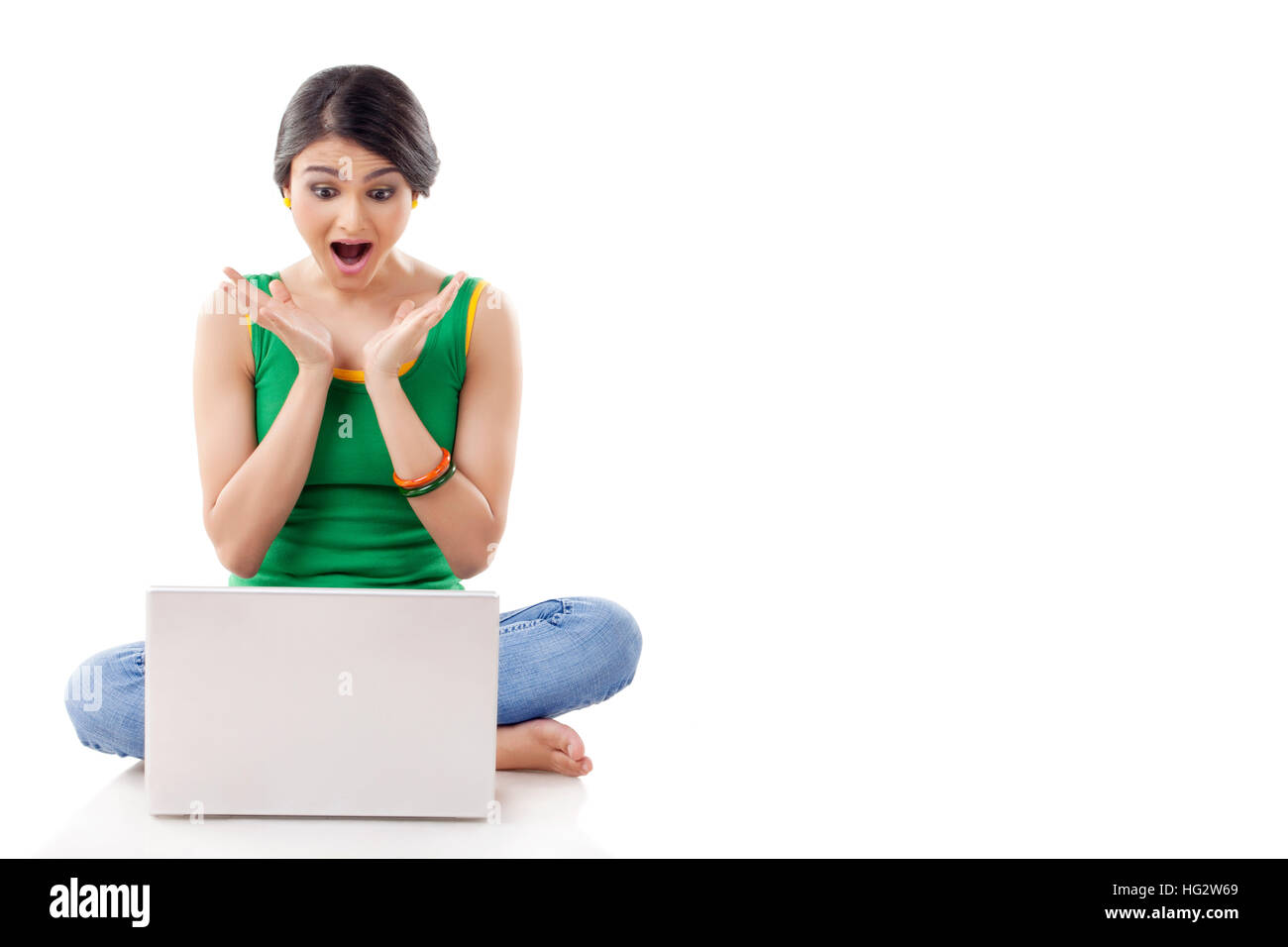 Junge Frau sitzt mit Laptop Stockfoto