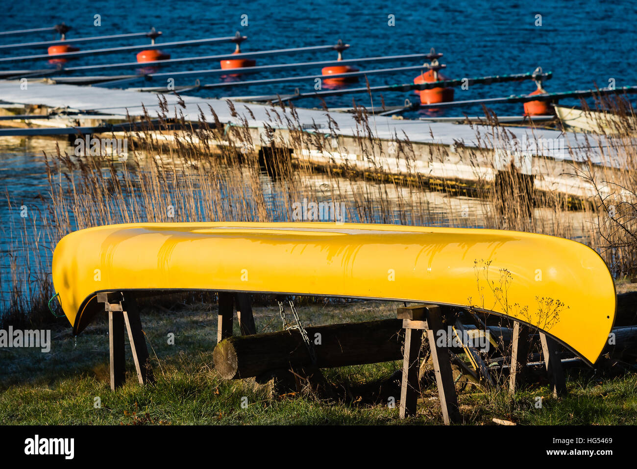 Umgestürzten gelb Kanu auf Stelzen mit Marina im Hintergrund. Stockfoto