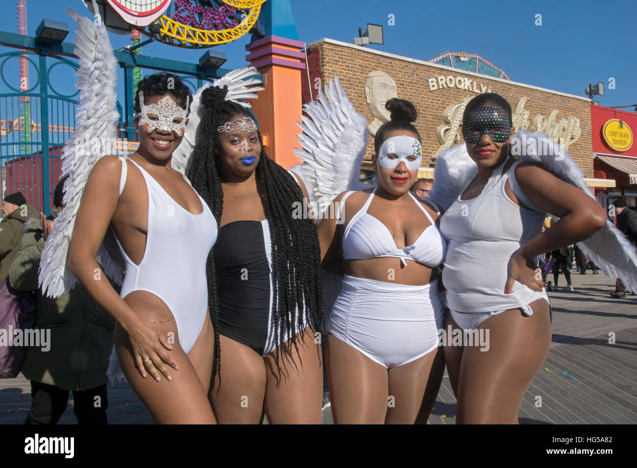 4 Frauen mit weißen Engelsflügel & Masken posiert für ein Foto an der Polar Bear Club jährlichen Winter-Swim in Coney Island Brooklyn New York City Stockfoto