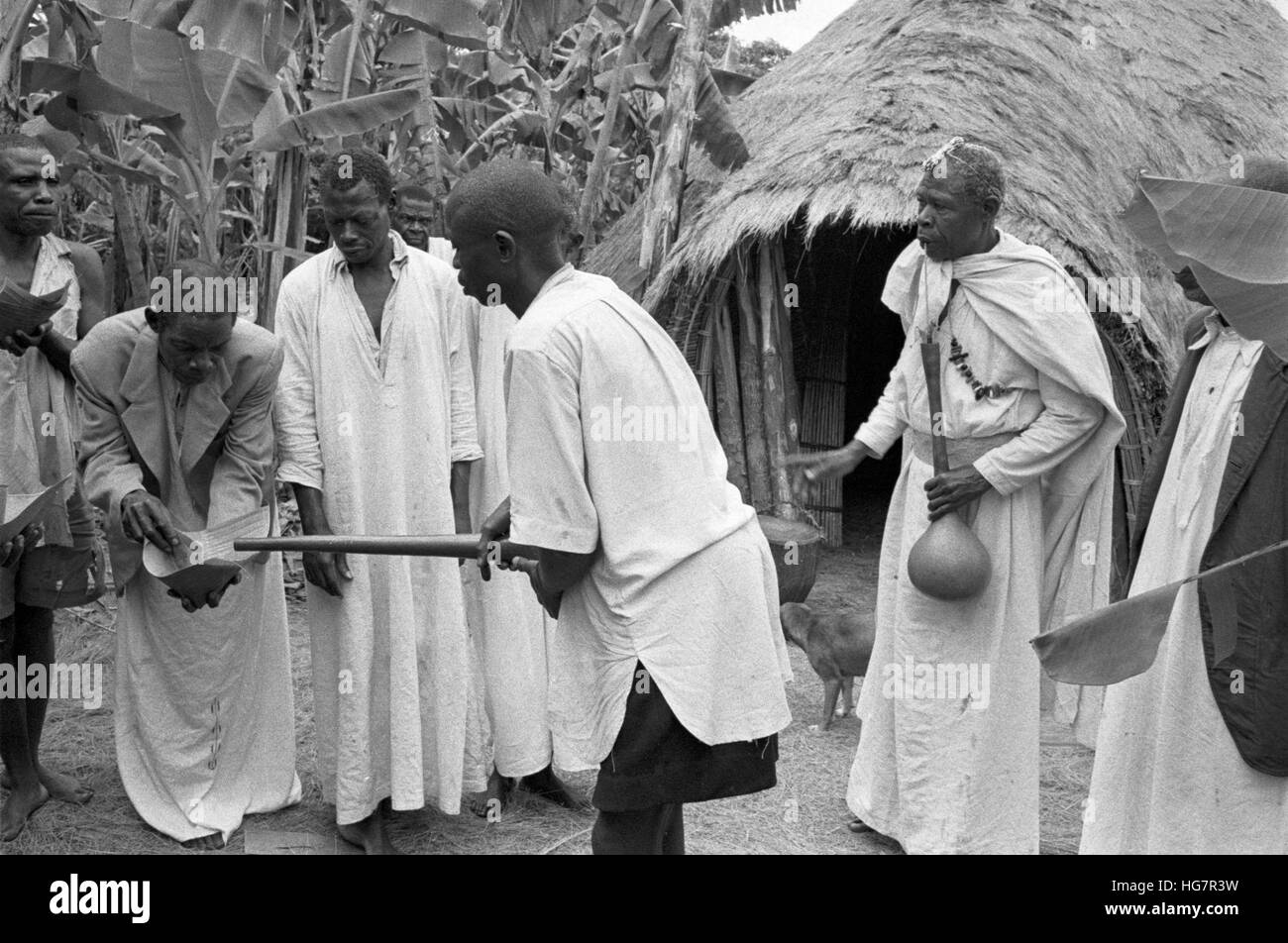 Ein afrikanischer Medizinmann, die Aufsicht über die Abgabe von alkoholischen Getränken Stockfoto