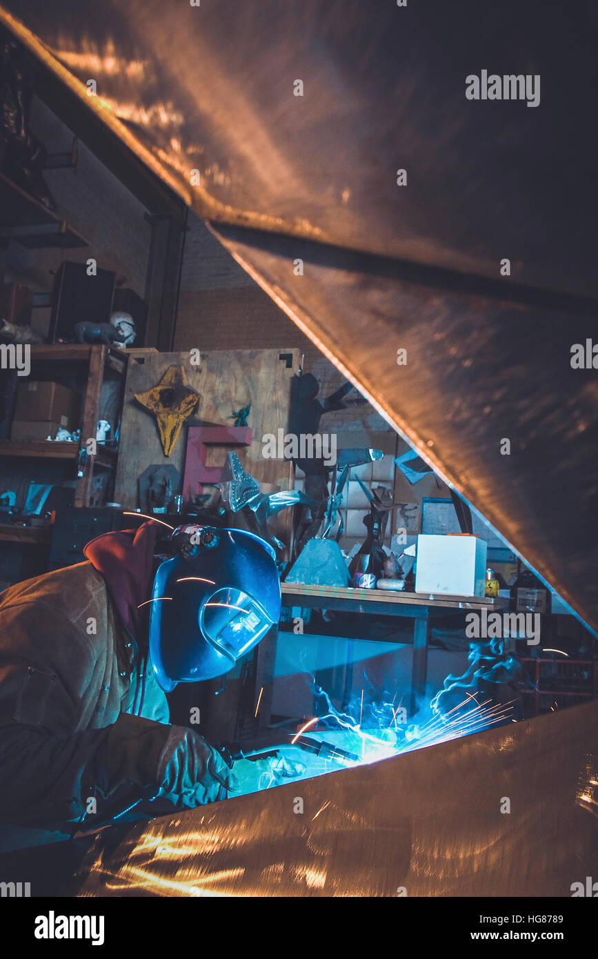 Seitenansicht des Arbeiters in Werkstatt Schweißen Stockfoto