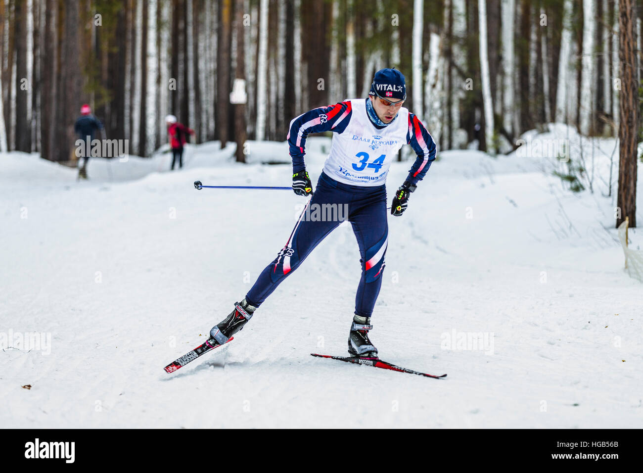 männlichen Skifahrer Sportler Männer im Winter Wald freien Stil während der Meisterschaft auf Langlauf Stockfoto