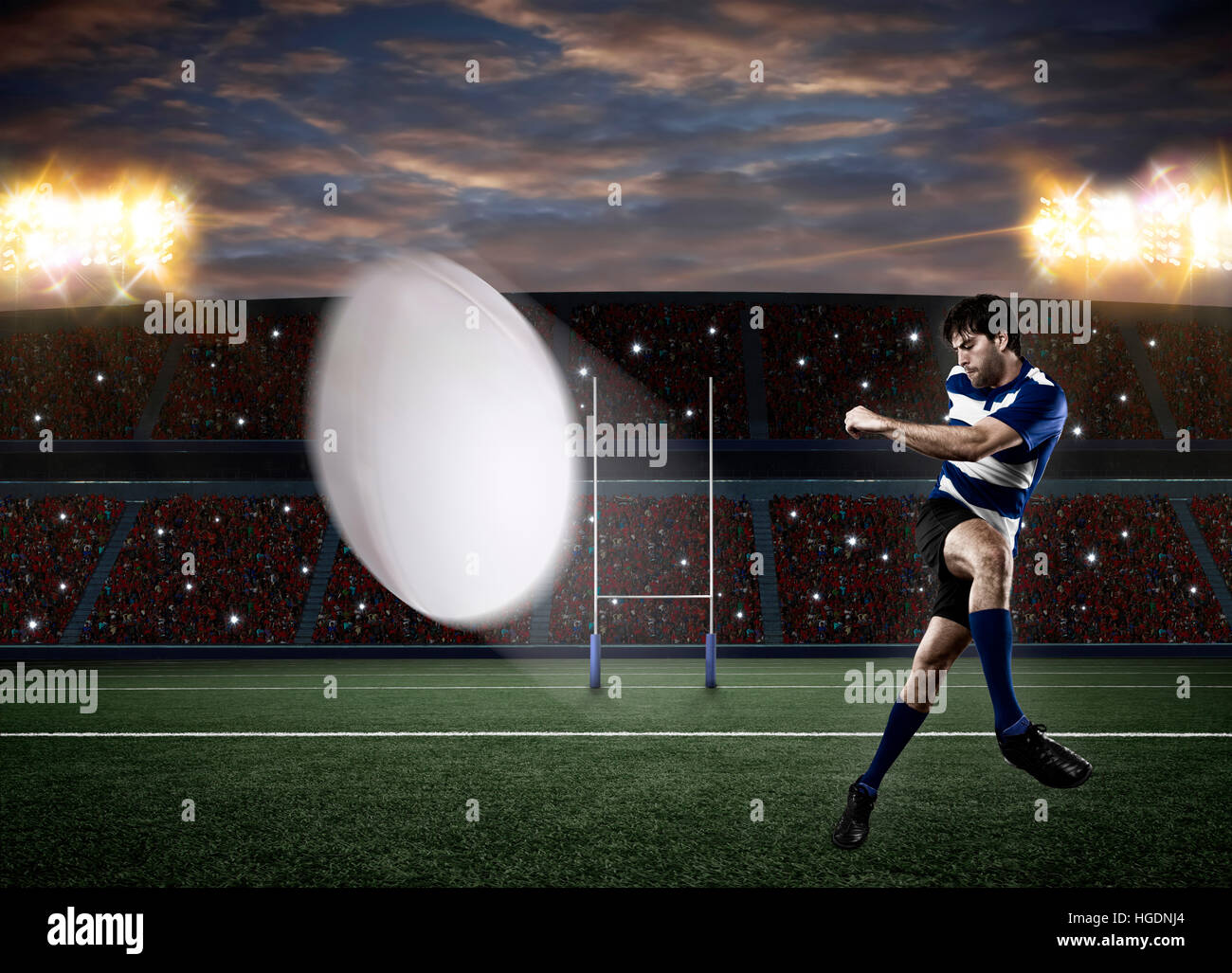 Rugby-Spieler in einer blauen Uniform einen Ball auf einem Stadion. Stockfoto