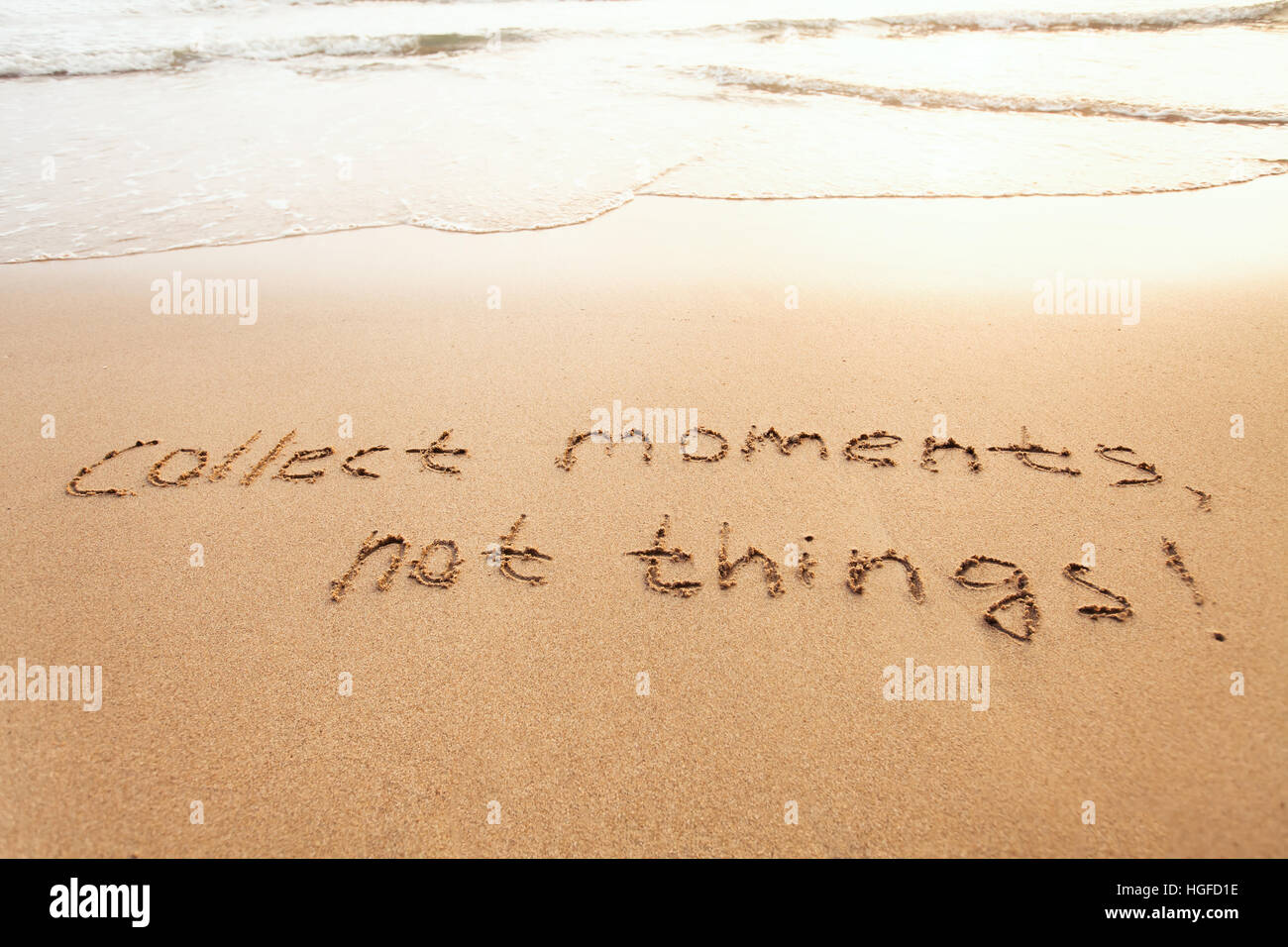 sammeln Sie Momente, nicht Dinge - Glück Konzept glücklich Lebensstil inspirierend Zitat, genießen Sie das Leben, Text auf sand Stockfoto