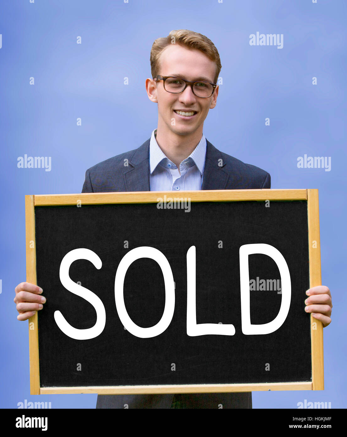 junger Geschäftsmann mit Schild mit dem Wort verkauft Stockfoto