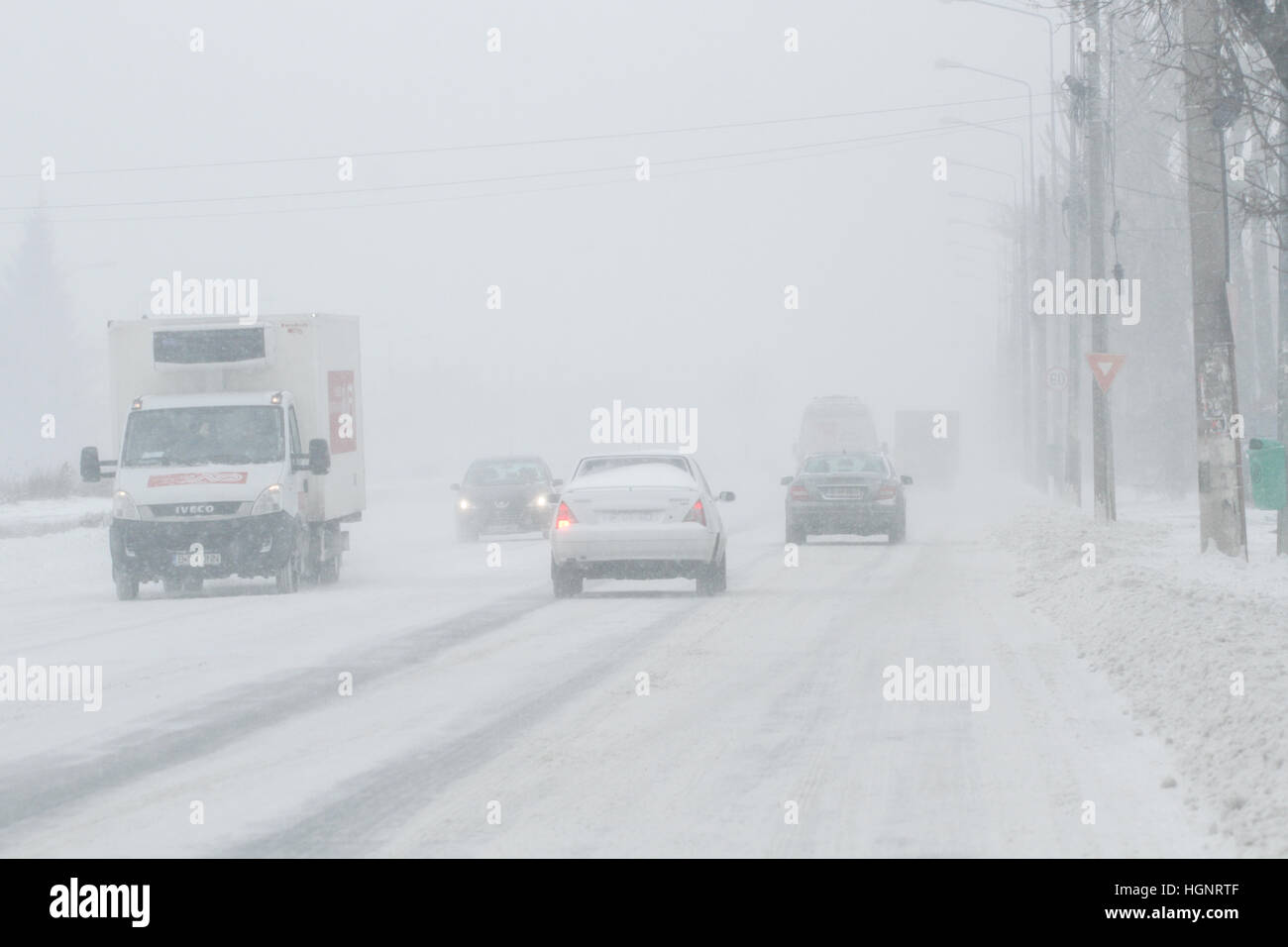 Bukarest, Rumänien, 25. Januar 2016: Autos sind vorbei an einem verschneiten Straße während eines Schneesturms in Bukarest. Stockfoto