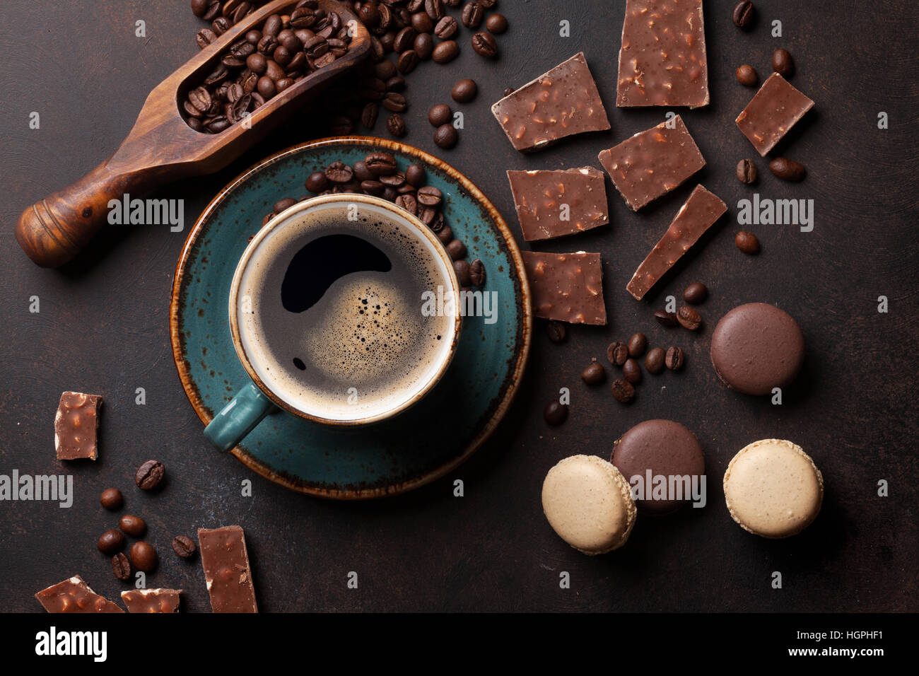 Tasse Kaffee, Bohnen, Schokolade und Amaretti auf alten Küchentisch. Ansicht von oben Stockfoto