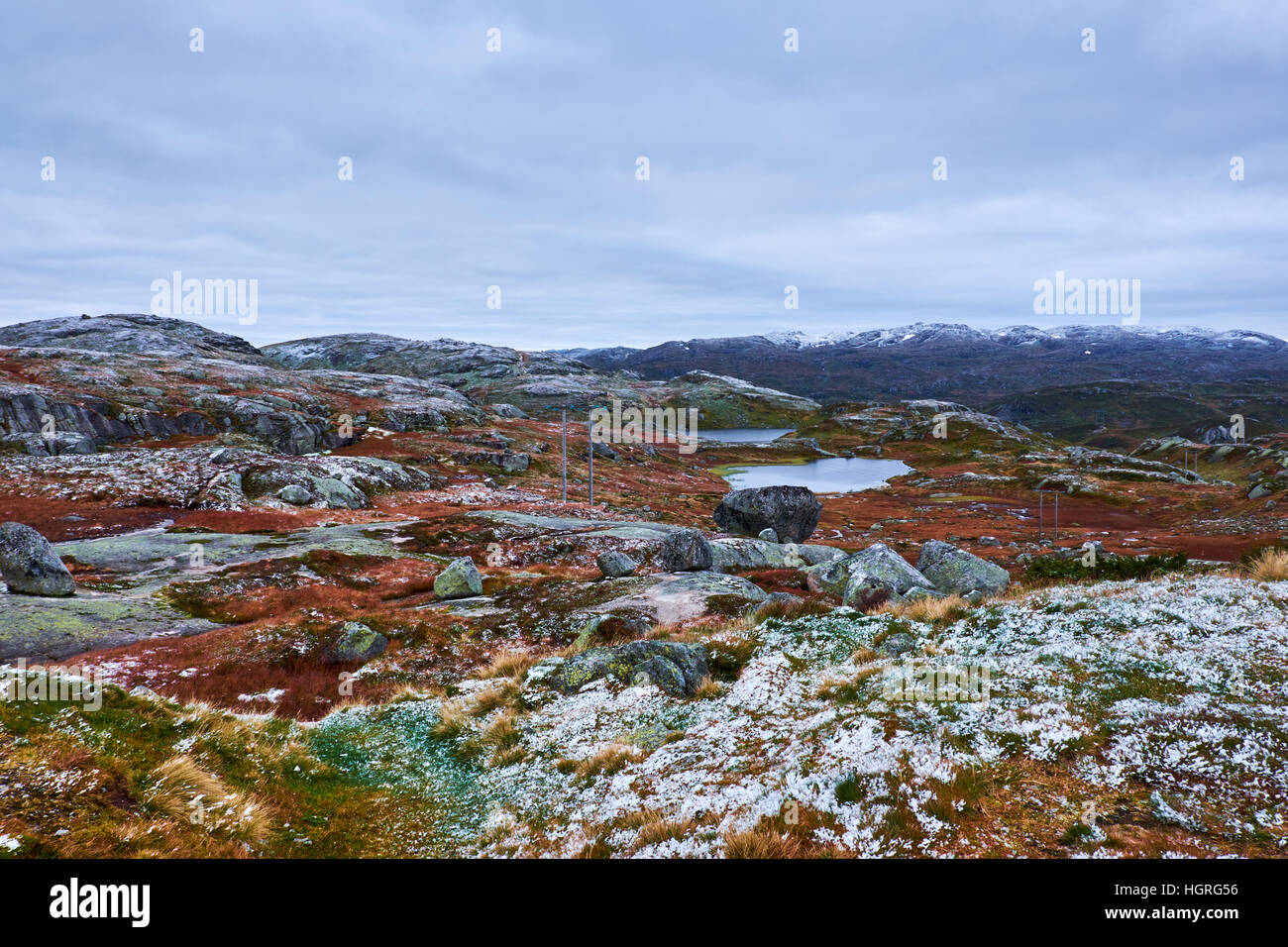 Norwegische Berglandschaft mit Bergseen, Felsen und Schnee über die grobe Bodenvegetation besprüht Stockfoto