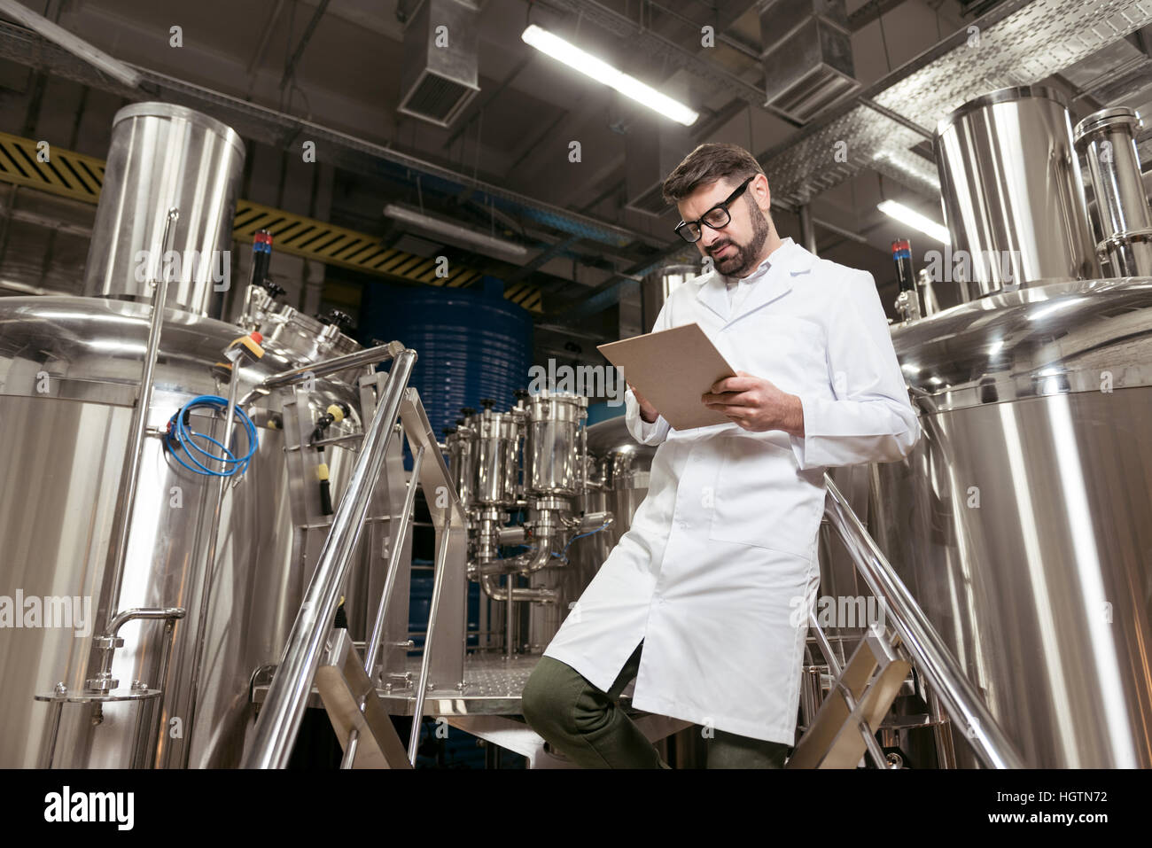 Zufrieden Man Notizen in Bierfabrik Stockfoto