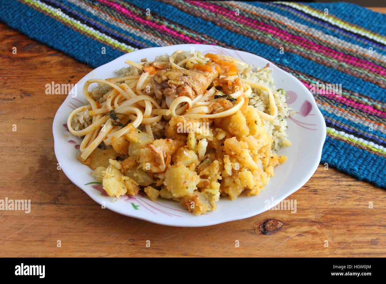 Typisch peruanische Anden Mahlzeit aus Reis, Kartoffeln, Nudeln und Huhn Stockfoto