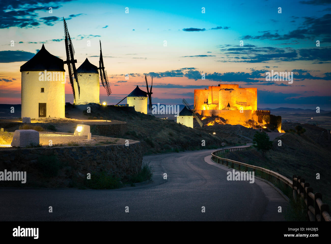 Windmühlen und schloss nach Sonnenuntergang, Consuegra, Kastilien-La Mancha, Spanien Stockfoto