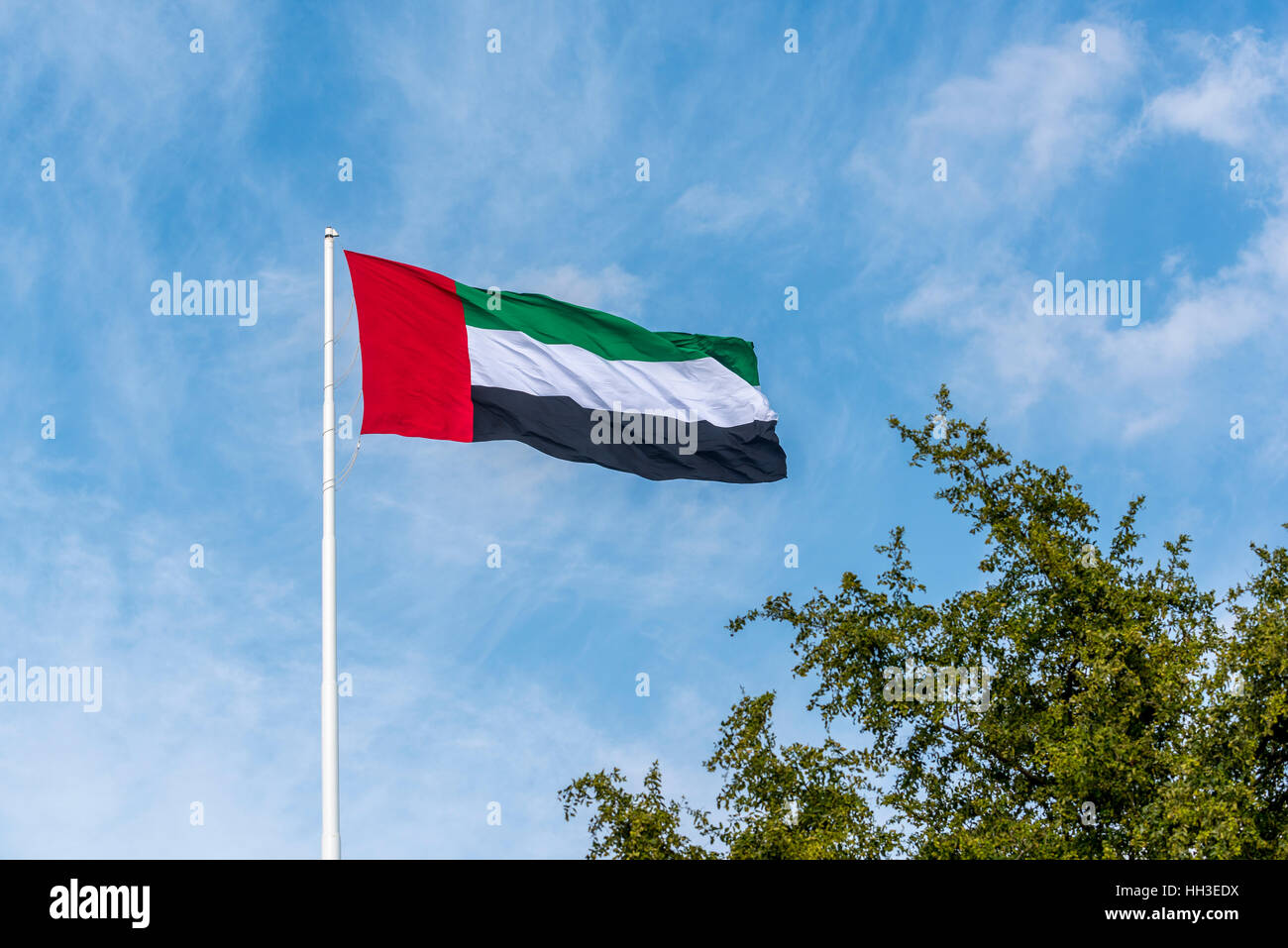 Nationalflagge von den Vereinigten Arabischen Emiraten vor blauem Himmel Stockfoto