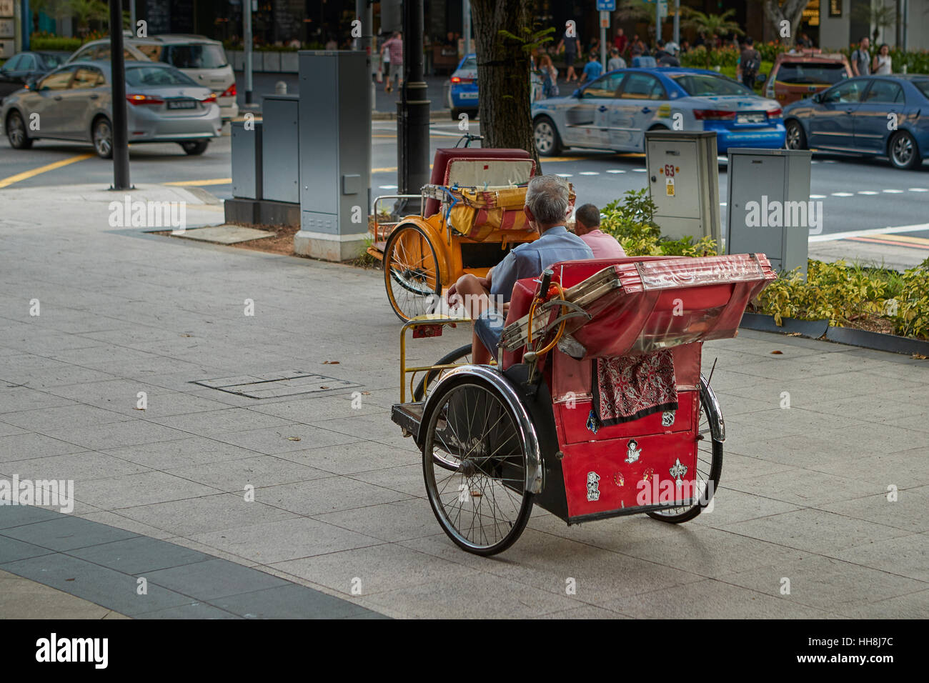 Zwei Zyklus Rickshaw Hausierer warten in Singapur. Stockfoto