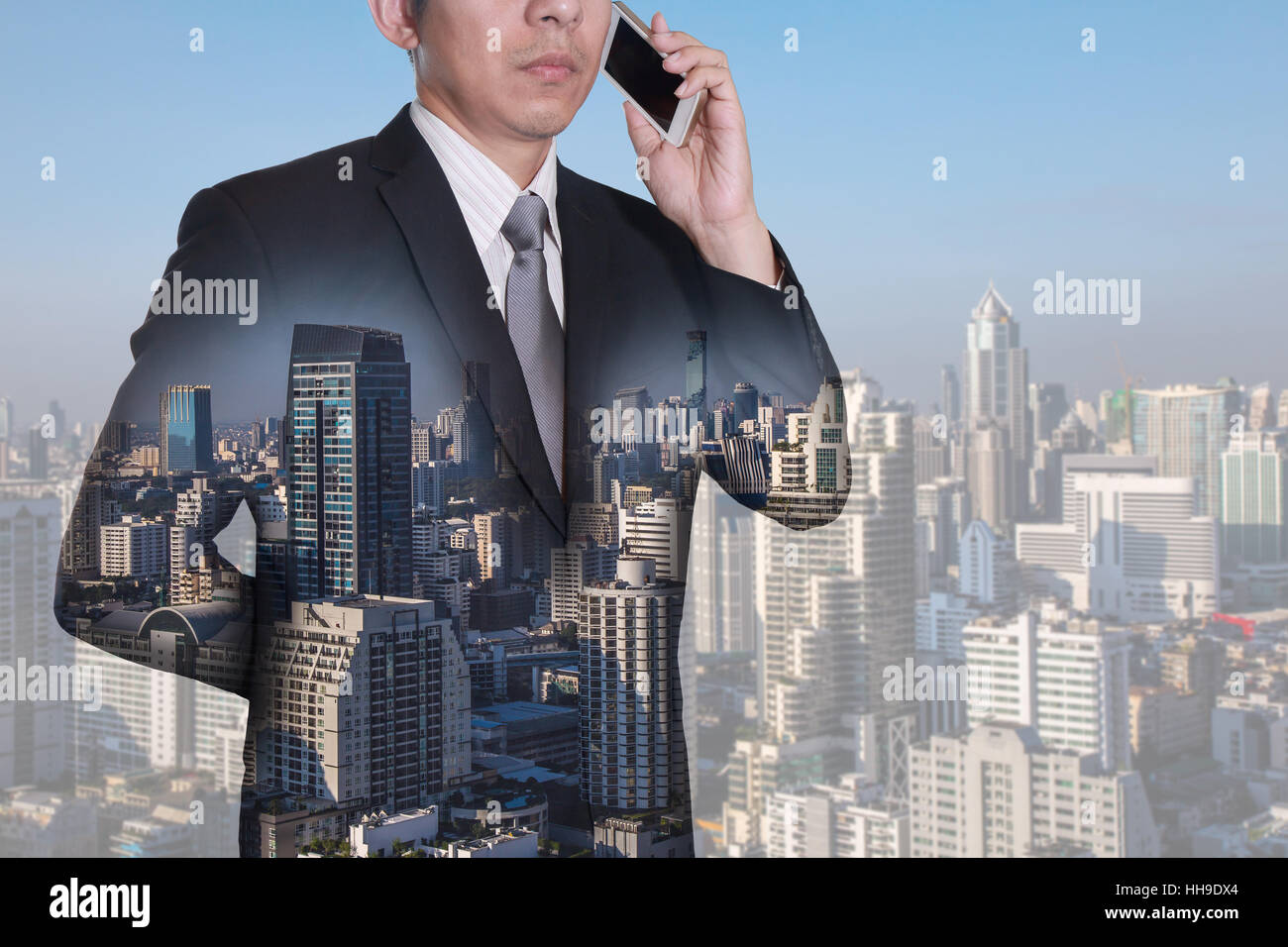 Doppelbelichtung Geschäftsmann mit Smartphone und Tag Stadt aufrufen Stockfoto