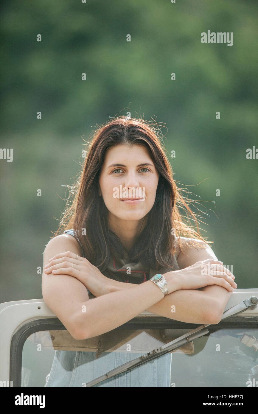 Eine Frau, stehend in einem Jeep, schaut sich um, die Landschaft. Stockfoto