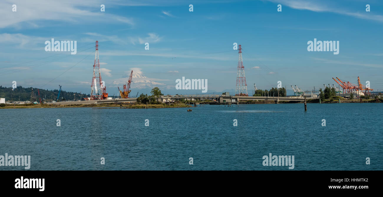 Mount Rainier erhebt sich hinter Stromleitungen am Port of Tacoma. Stockfoto