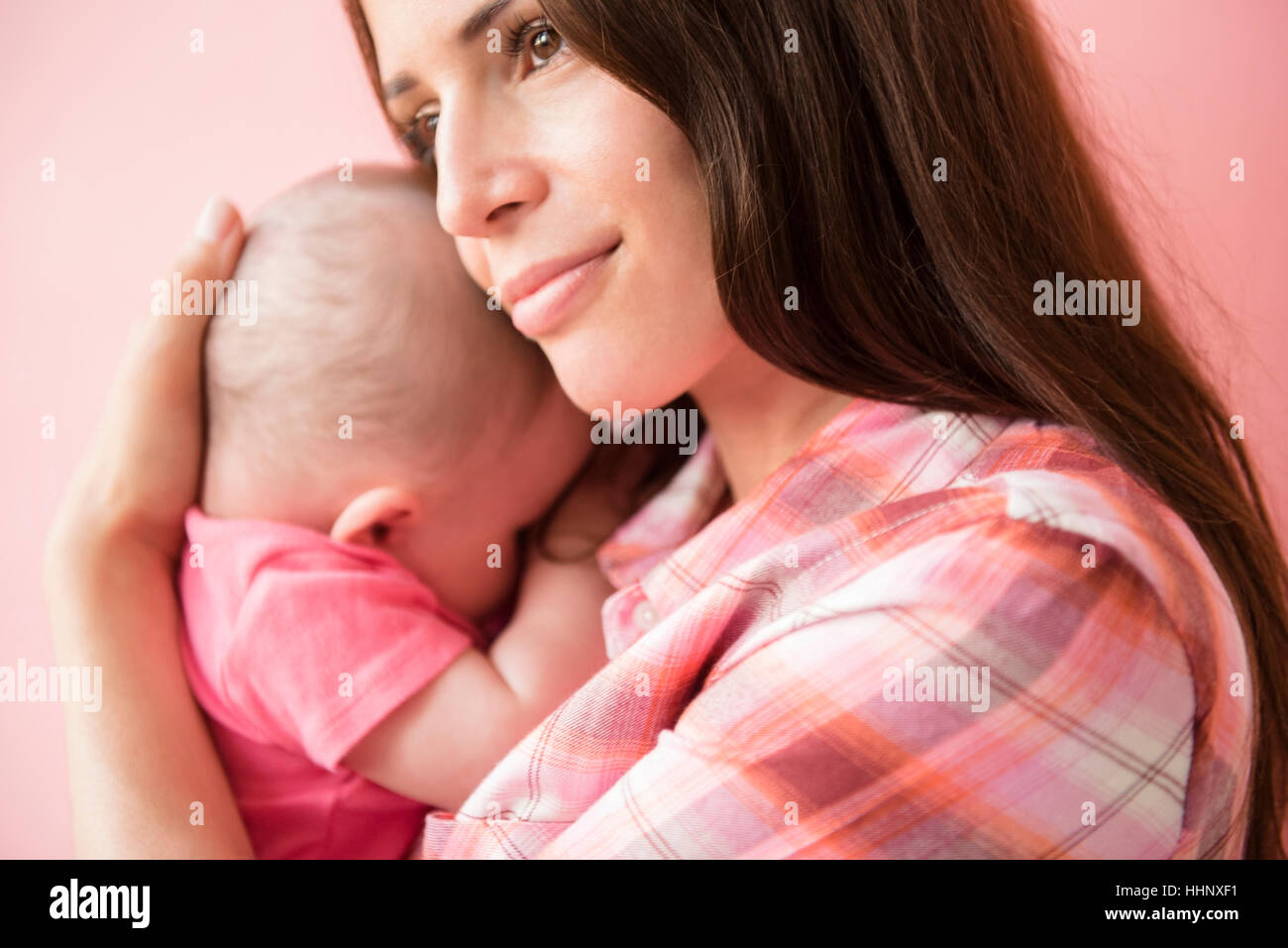 Kaukasische Mutter umarmt Baby Tochter Stockfoto