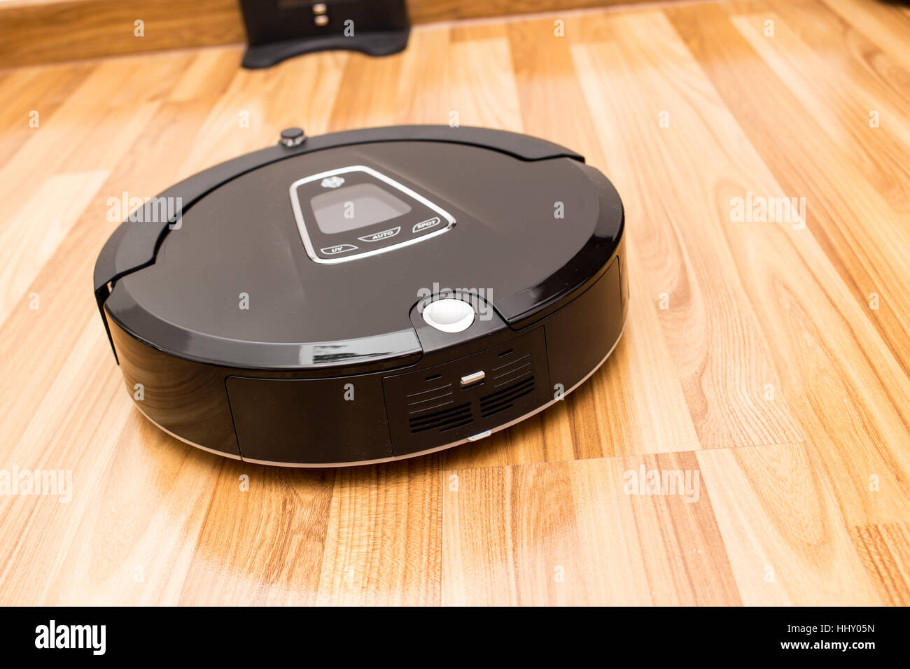 Roboter-Staubsauger auf Holz Parkett, Smart Vakuum, neue Technologie Hausarbeit zu automatisieren. Stockfoto