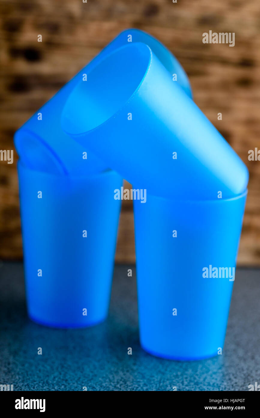 Vier leere blaue Plastikbecher auf einer Küchenarbeitsplatte Stockfoto