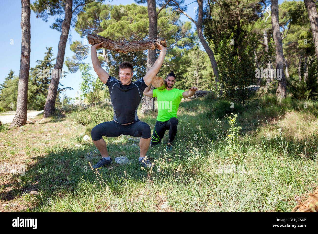 Zwei junge Männer tun Gewichtheben Training mit Baumstämme im Wald, Split, Dalmatien, Kroatien Stockfoto