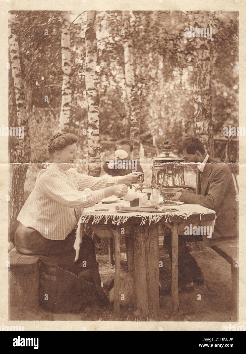 Retro-Fotografie. Familie am Tisch im Garten, ca. 1905 Stockfoto