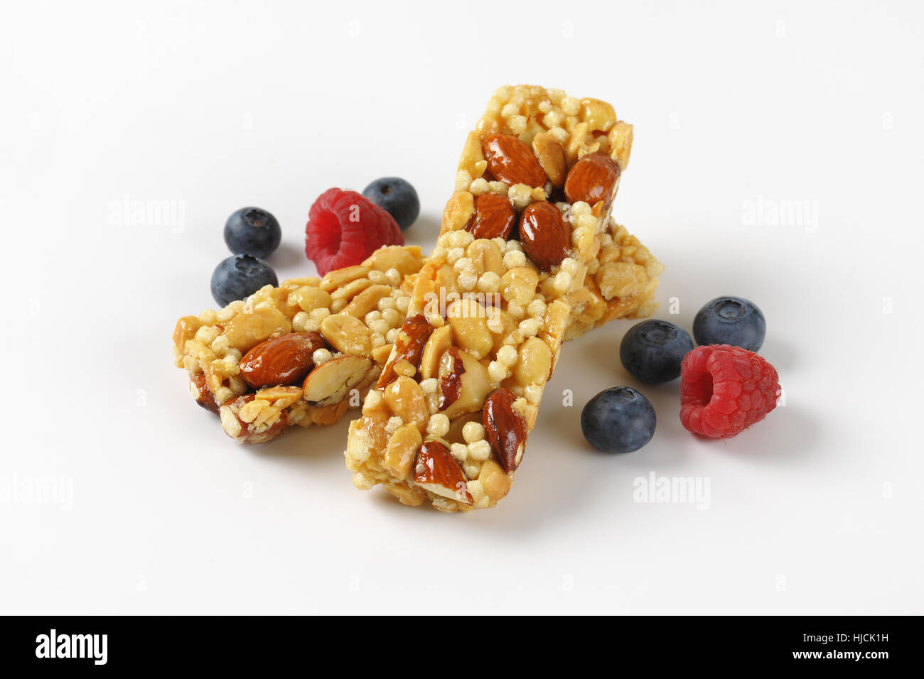 zwei Snack-Bars mit Mandeln und Nüssen und Beerenobst auf weißem Hintergrund Stockfoto