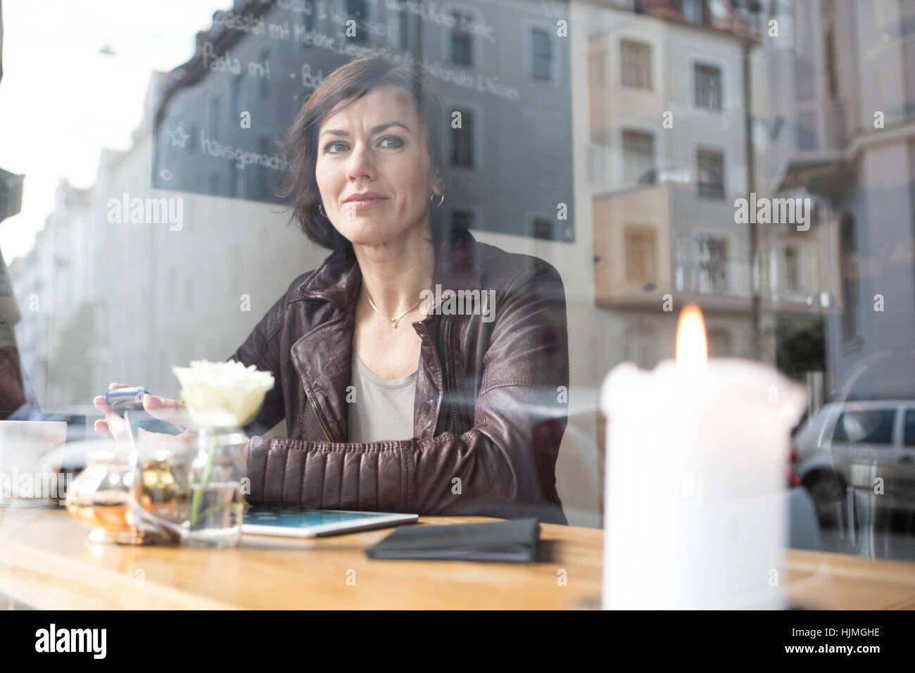 Frau in einem Café aus Fenster Stockfoto