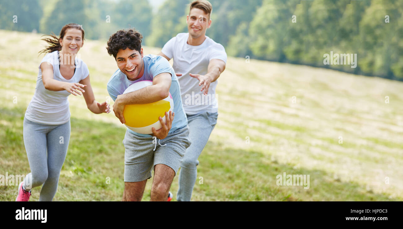 Jugendliche spielen mit Ball im Sommer im park Stockfoto